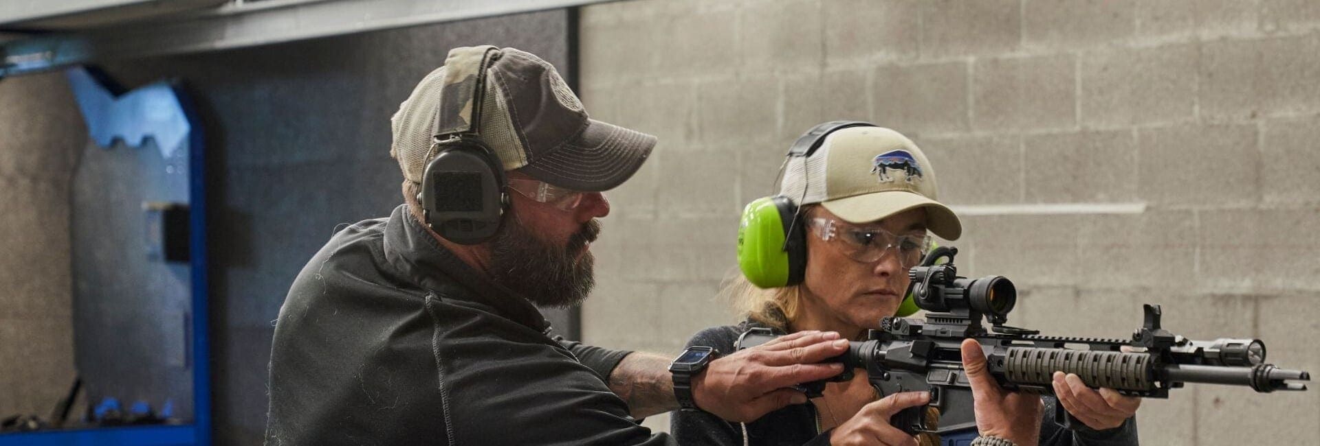 a man and woman pointing a gun