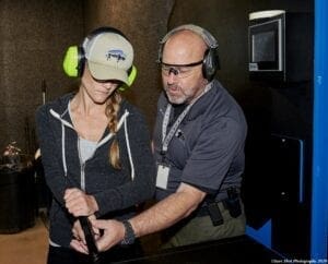 Are You Really Good Enough to Carry? 4 A man helping a woman train in gun use. | Are you ready to carry?